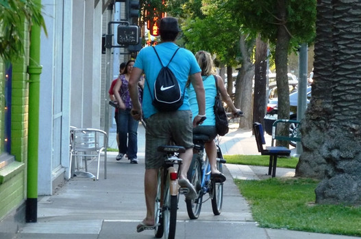 riding bike on sidewalk